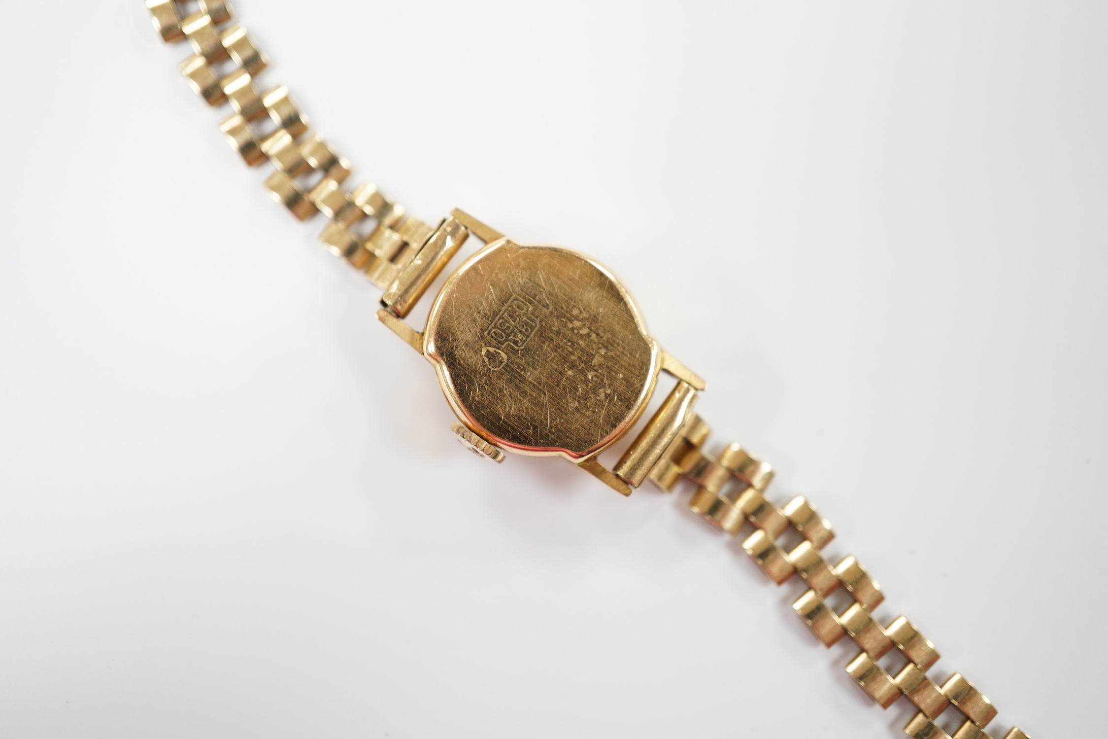 A lady's 18ct gold manual wind Cristal Watch, on a 1960's 9ct gold bracelet, overall length 16cm